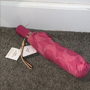 A pink Coach umbrella